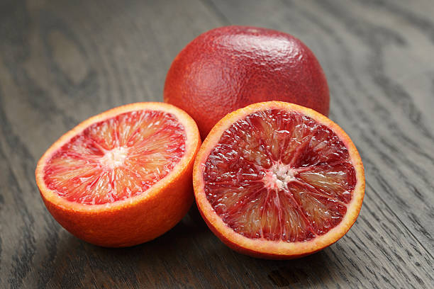 istock red sicilian oranges sliced on wooden table 474151310