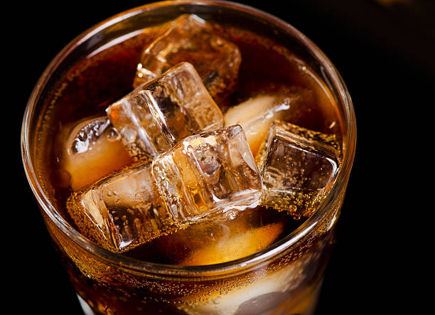 istock glass of cola with ice cube 474152160