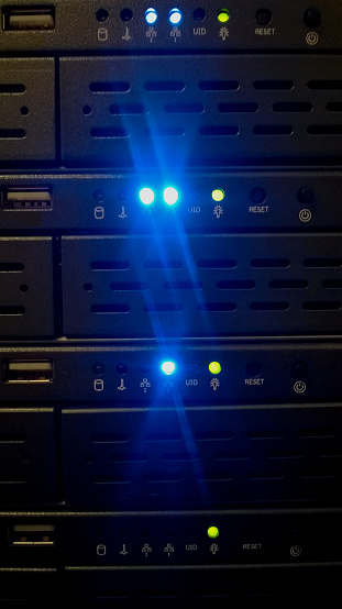 Servers in a hyperscale cloud datacenter, front, with blue glow.