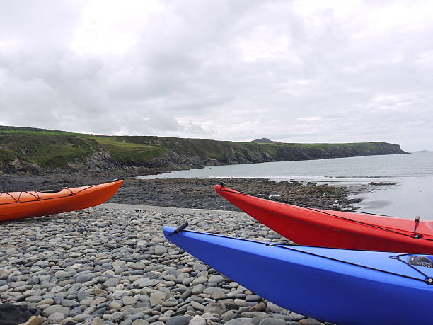 istock three canoes at edge of sea 474164282