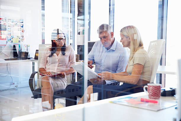 istock Group of colleagues talking in an office 474168048
