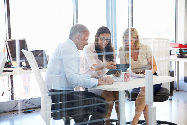 istock Group of colleagues meeting around a table in an office 474168060