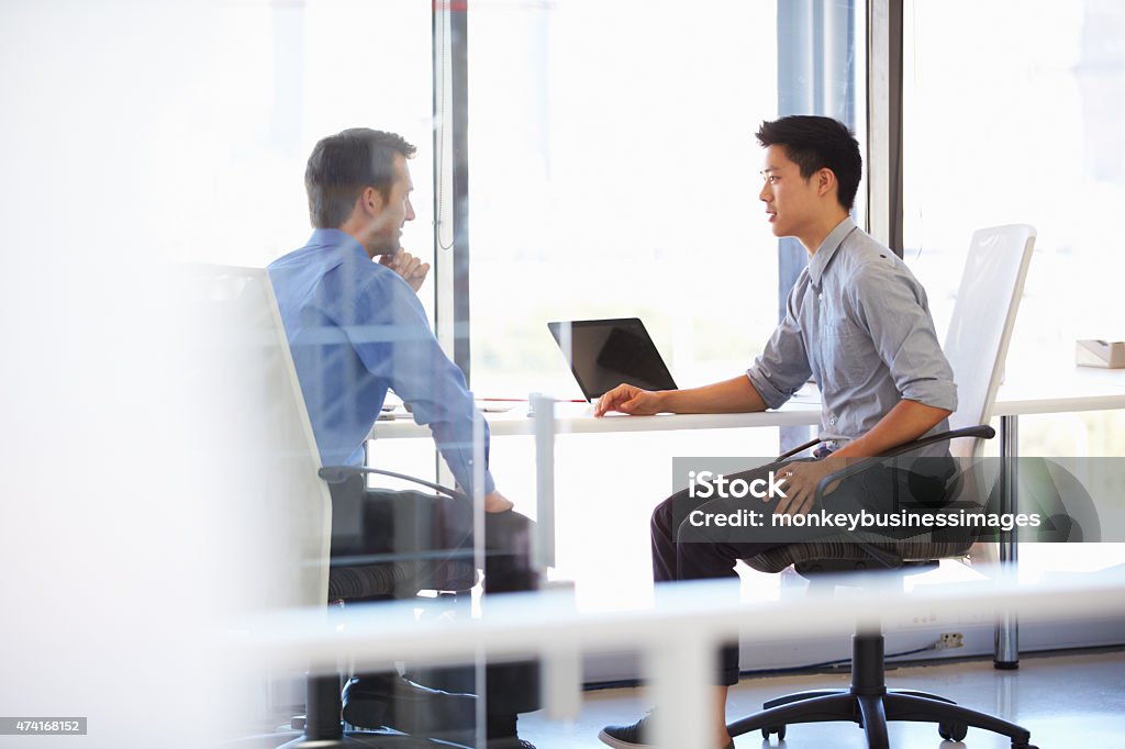 Two men working in a modern office Discussion Stock Photo