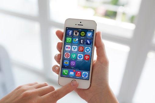 Alushta, Russia - July 14, 2014: Displaying social media network program known brands on the screen iPhone from Apple.