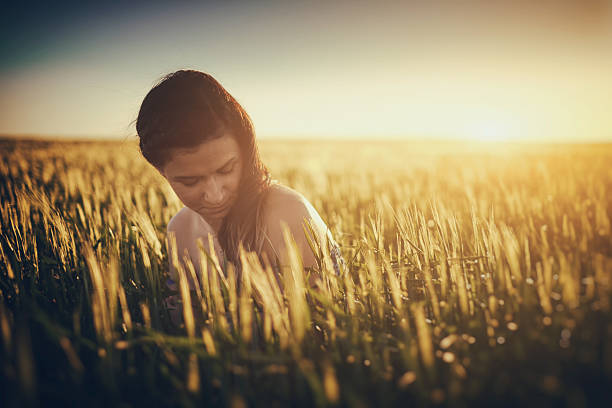 istock Beautiful young woman on the spring wheat field 474172948