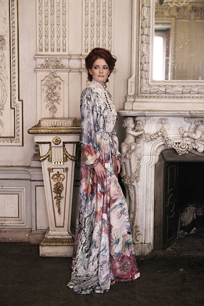 istock woman  posing next to the fireplace 474173000