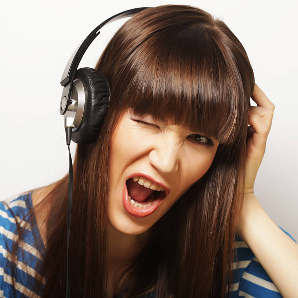 istock Young happy woman with headphones 474173056