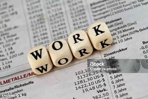 Work Word Built With Letter Cubes On Newspaper Background Stock Photo - Download Image Now