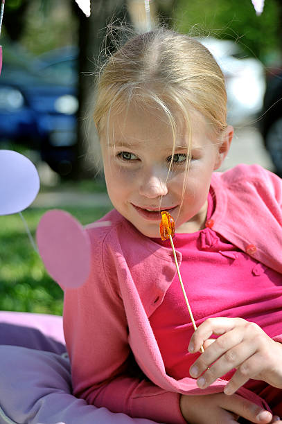 istock Little girl with lollipop 474173520