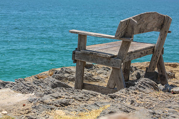 istock Scenic view of beach and ocean with bench 474175215