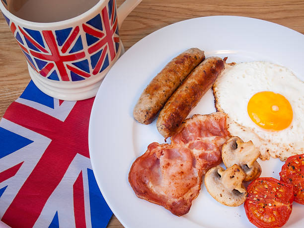 istock Close-up fried breakfast with  tea and british flag 474175363