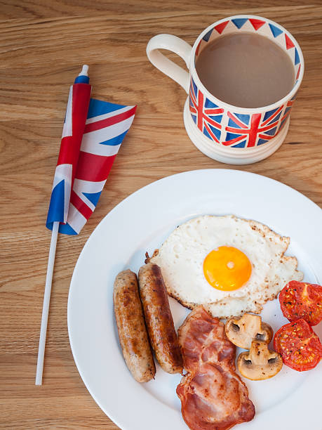 istock Bacon and eggs with cup of tea  british flag 474175381