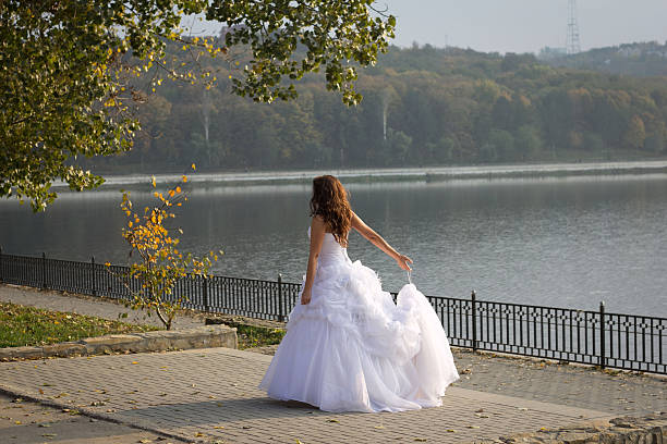 Bride spinning in a white dress stock photo