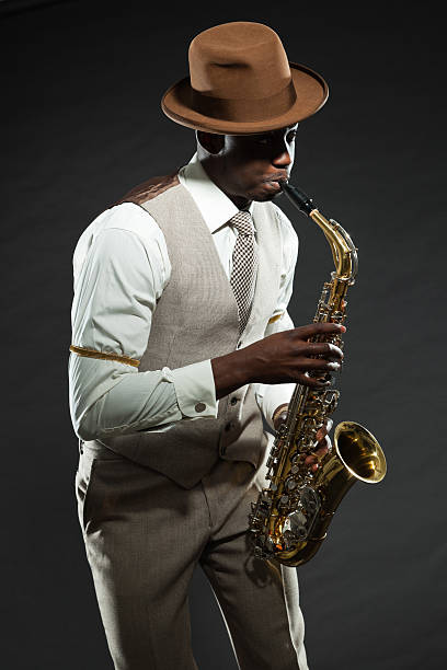 istock Black american jazz saxophone player. Vintage. Studio shot. 474176441
