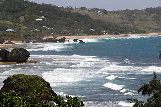 landscape view over the rough atlantic ocean and bathsheba on the hazy east coast of Barbados