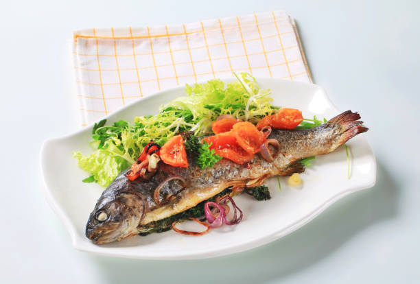 istock Baked trout with tomatoes and green salad 474178306