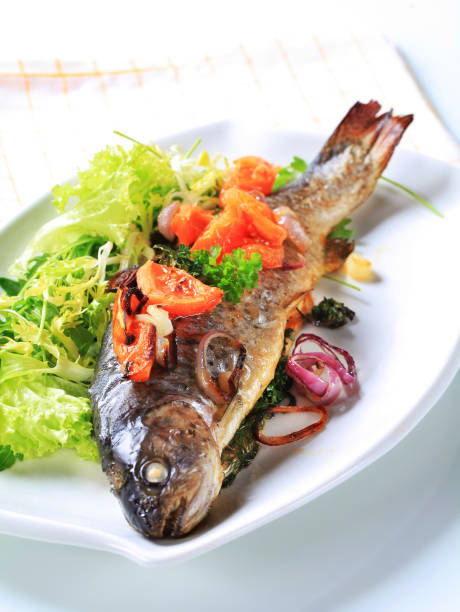 istock Baked trout with tomatoes and green salad 474178452