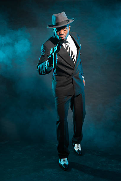 istock Black american mafia gangster man in suit with gun. 474178621