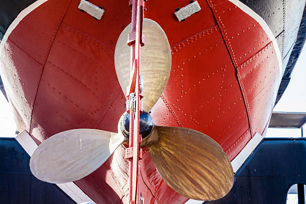 Brass Propellor metal rivet coloured hull of retired steam tug vessel on dry-dock museum