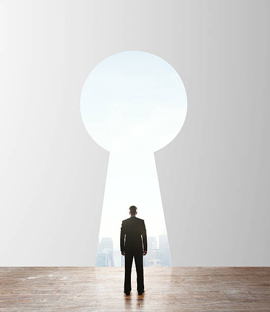 istock businessman looking to keyhole 474179027