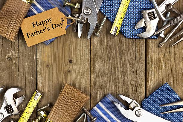 istock Fathers Day tag with tools and ties frame on wood 474179584