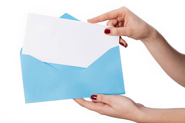 istock Women's hand with envelope and card for your own text 474179741