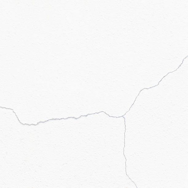 istock Cracked and broked white cement wall 474180106