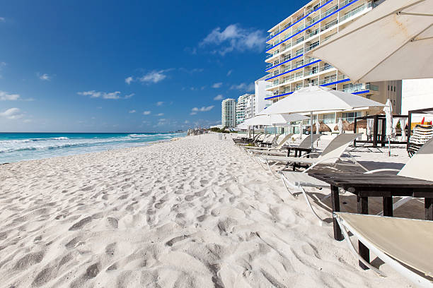 istock Vacation on caribbean beach with sun umbrellas and beds 474182250