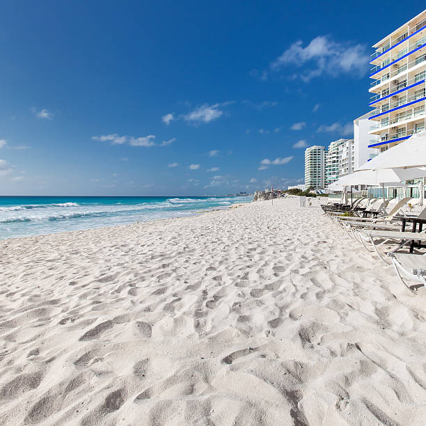 istock Vacation on caribbean beach with sun umbrellas and beds 474182254