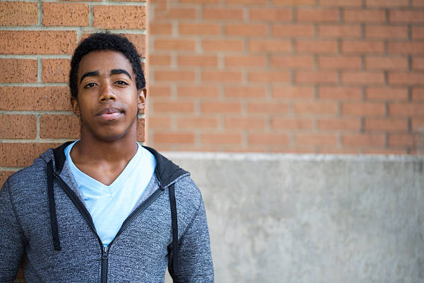African American teenager looking to the future. Profile of an African American Teenager with copy space. serious black teen stock pictures, royalty-free photos & images