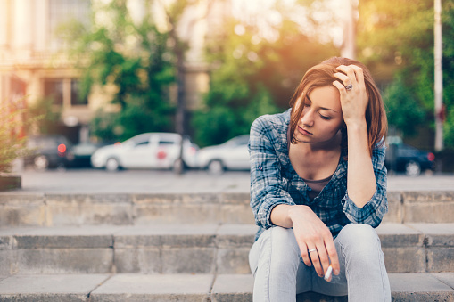 Thoughtful girl with cigarette  - copyspace