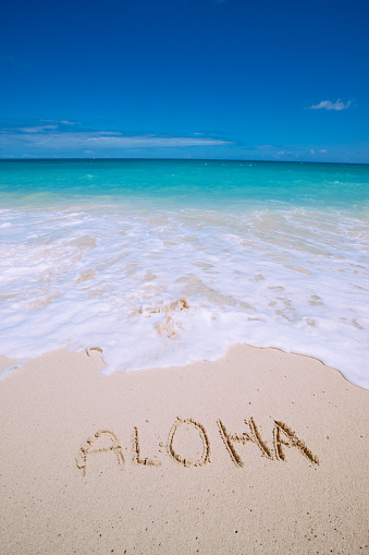 Aloha sign in white sand, Hawaii beach