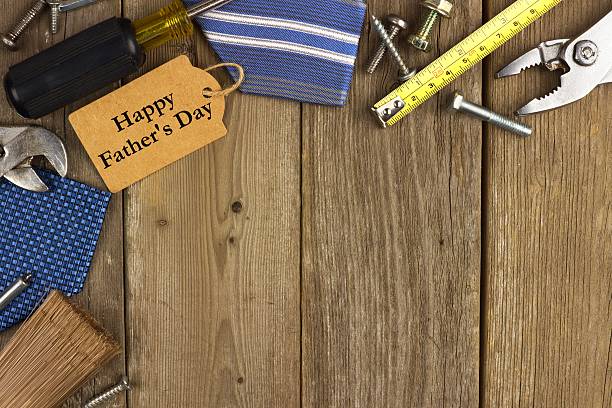 istock Fathers Day tag with tools and ties border on wood 474190006