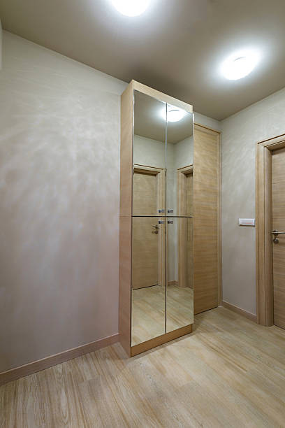 istock Modern interior with bright wooden wardrobe with mirror 474190338