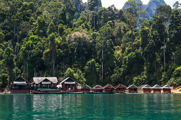 istock Raft residence floating over river with blue sky and forest 474190350