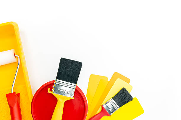 istock paint roller in tray with paint can and brushes 474192316