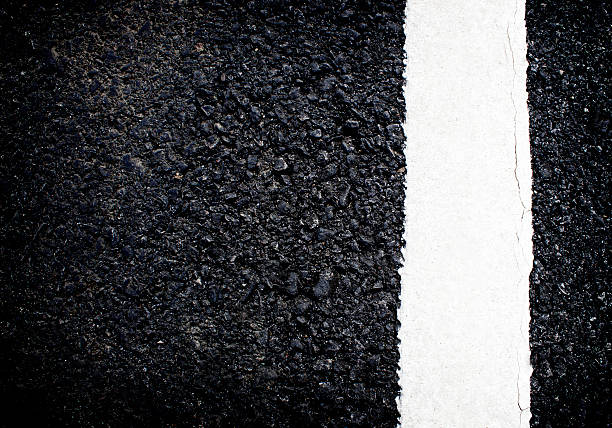istock white line on the road texture background 474192468