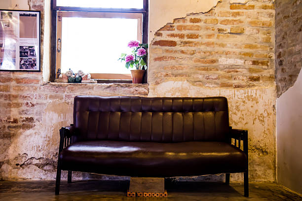 istock Black sofa in the old brick walls. 474192469
