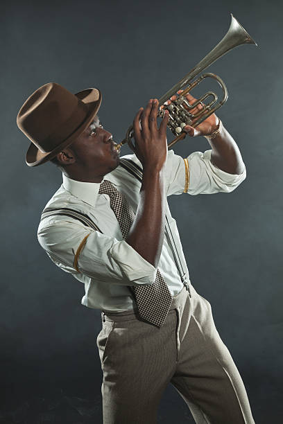 Black african american jazz trumpet player. Vintage. Studio shot. Black african american jazz trumpet player. Vintage. Studio shot. man trumpet stock pictures, royalty-free photos & images