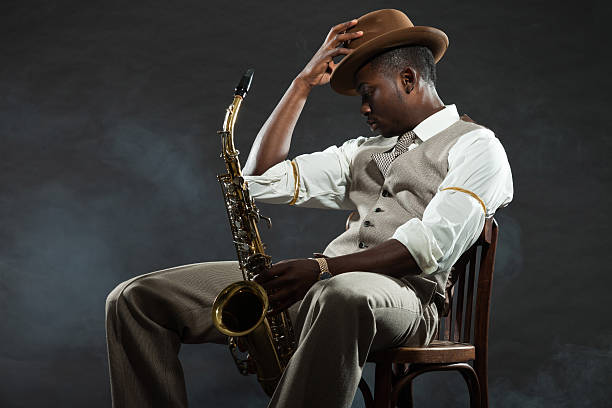 istock Black american jazz saxophone player. Vintage. Studio shot. 474194505