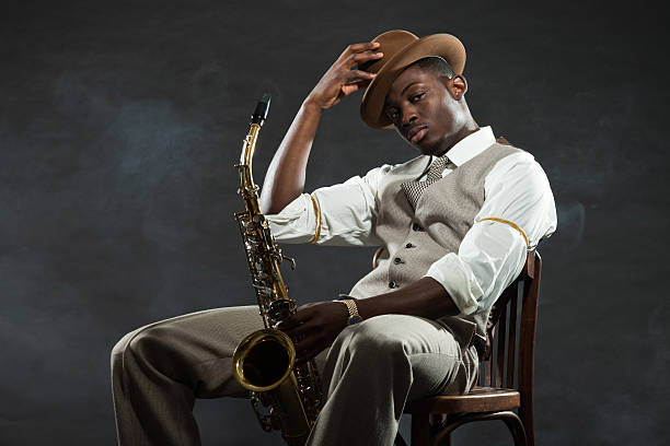 istock Black american jazz saxophone player. Vintage. Studio shot. 474194509