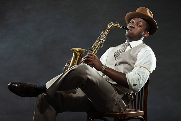 istock Black american jazz saxophone player. Vintage. Studio shot. 474194511
