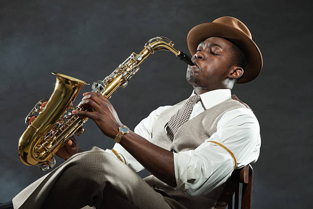 istock Black american jazz saxophone player. Vintage. Studio shot. 474194553