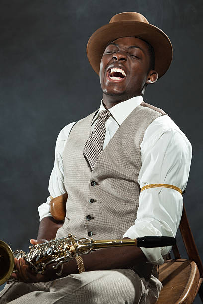 istock Black american jazz saxophone player. Vintage. Studio shot. 474194559