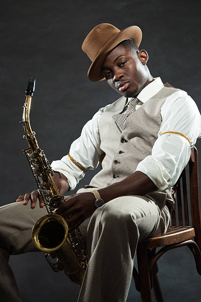 istock Black american jazz saxophone player. Vintage. Studio shot. 474194585