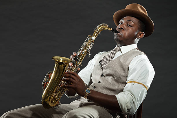 istock Black american jazz saxophone player. Vintage. Studio shot. 474194715