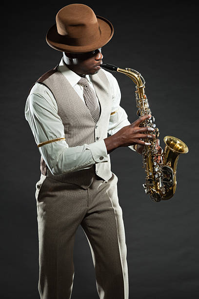 istock Black american jazz saxophone player. Vintage. Studio shot. 474194723