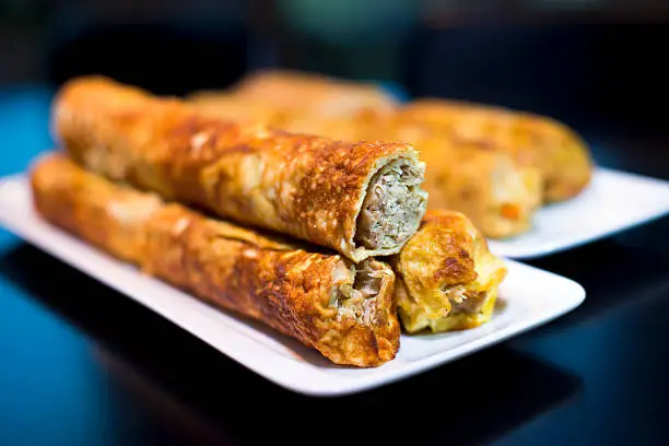 Photo of Rolls stuffed with meat and pancakes rolled in tube