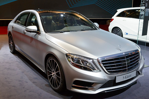 Amsterdam, The Netherlands - April 16, 2015: Mercedes-Benz S-Class plug-in hybrid luxury sedan on display during the 2015 Amsterdam motor show. People in the background are looking at the cars.