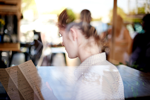 Shot of a young woman reading a menu in a coffee shophttp://195.154.178.81/DATA/i_collage/pu/shoots/804651.jpg